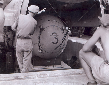 A "Fat Man" test unit being raised from the pit into the bomb bay of a B-29 