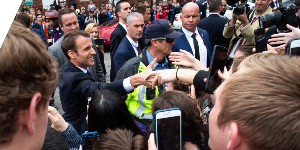 Emmanuel Macron greets a crowd
