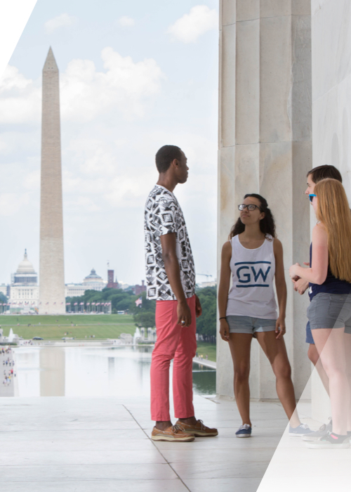 Students at the Lincoln Memorial with the Washington monument in the background.