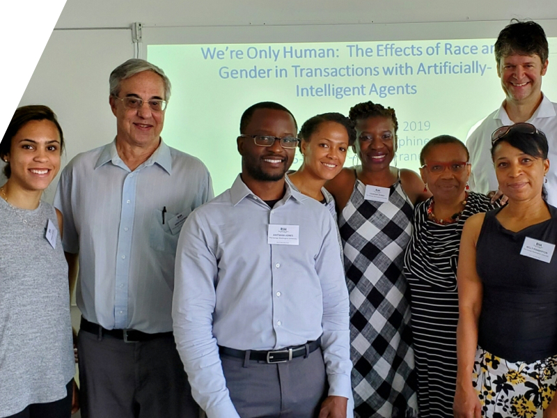 Group posing in front of presentation screen