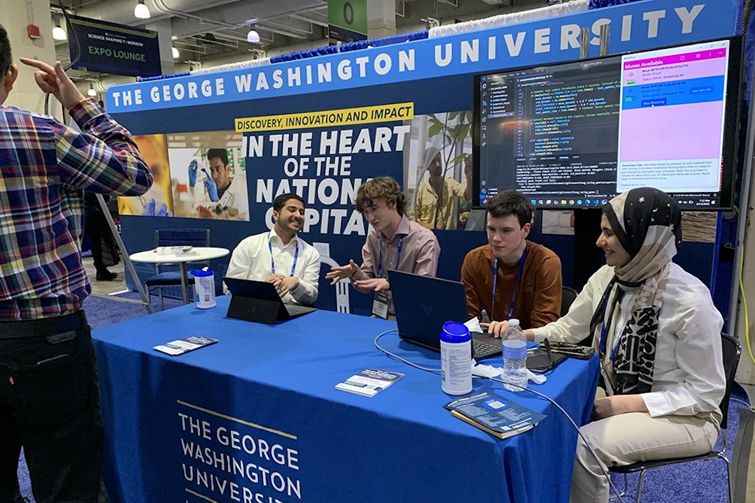 GW research community members table at the AAAS conference in Boston. MA