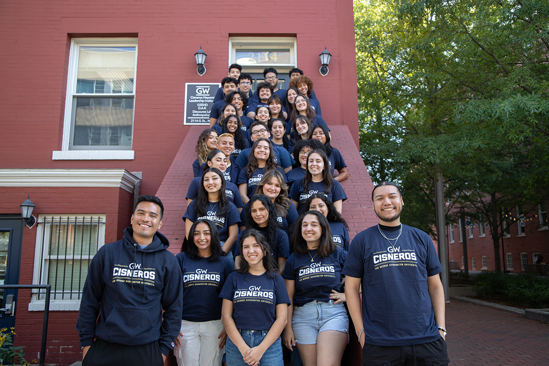 A group photo of Cisneros Scholars outside the Cisneros Institute building