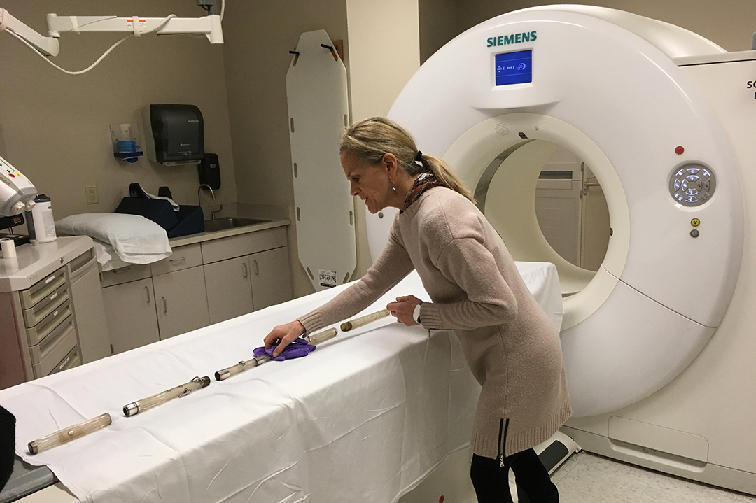 Carol Lynn Ward-Bamford, a curator with the Library of Congress, prepares a flute separated into sections for CT imaging at GW Hospital