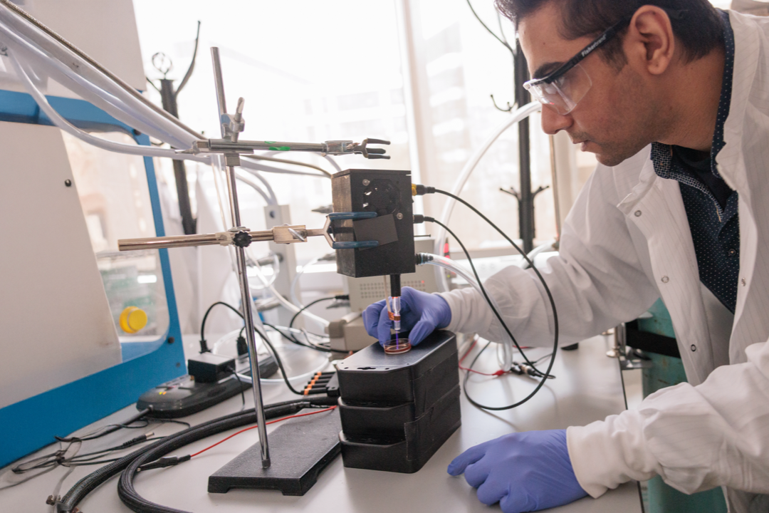A scientist conducts a test in a lab