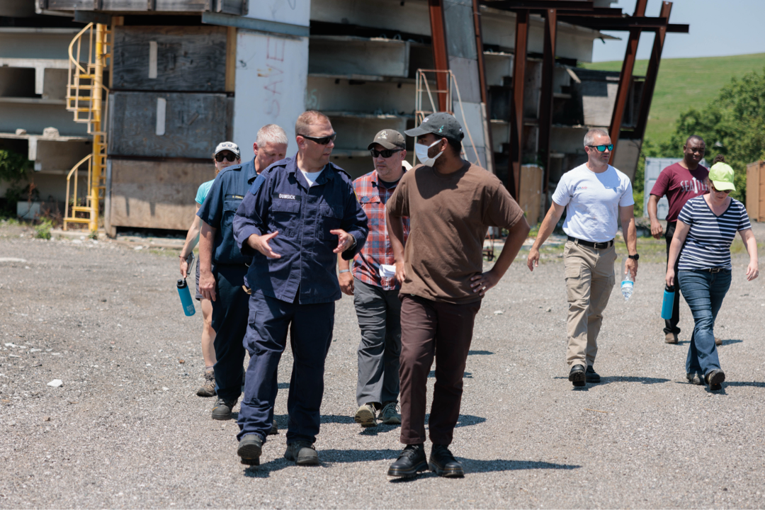 A group of people walk outdoors