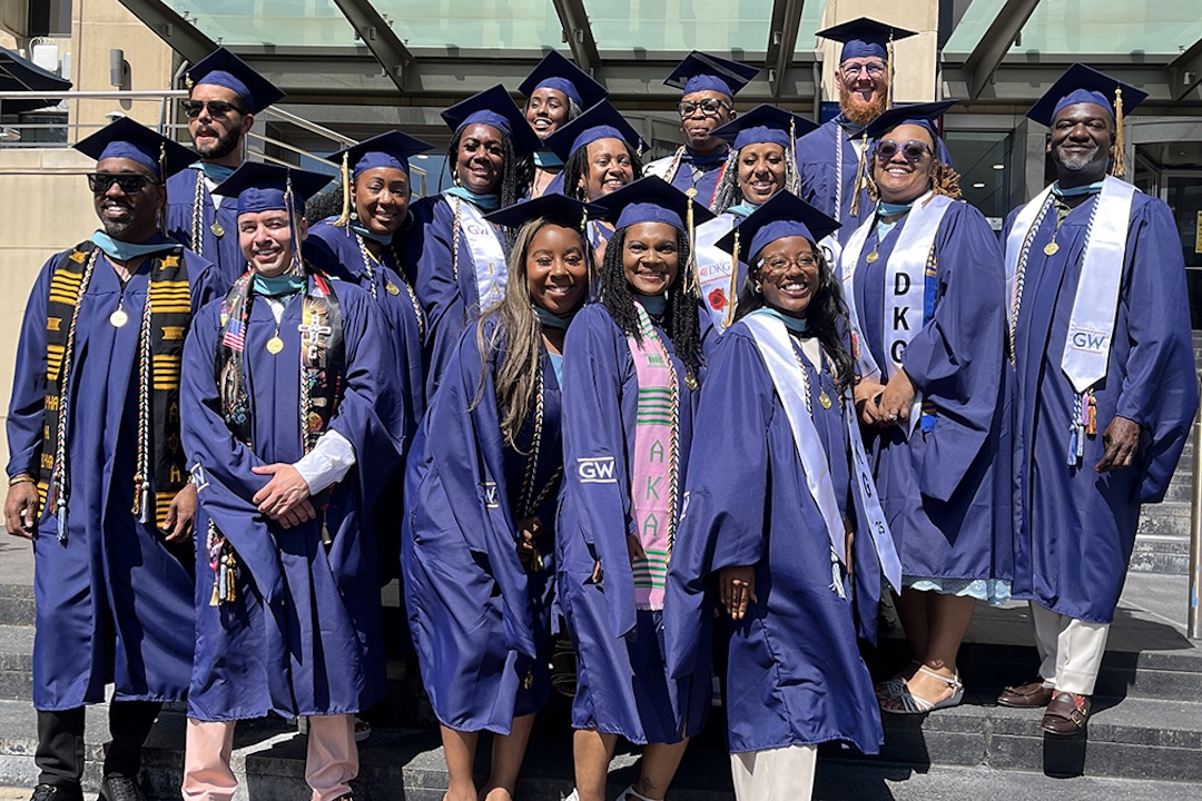 The GSEHD Educational Leadership and Administration program posed for photos their graduation attire in front of Gelman Library.