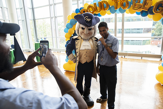 The George mascot poses with a man