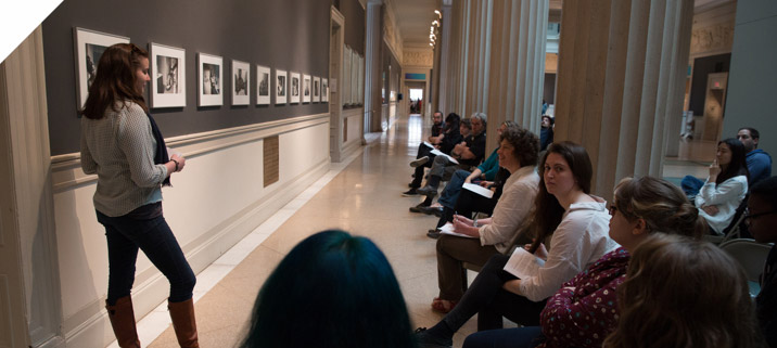 Student presenting art to a group