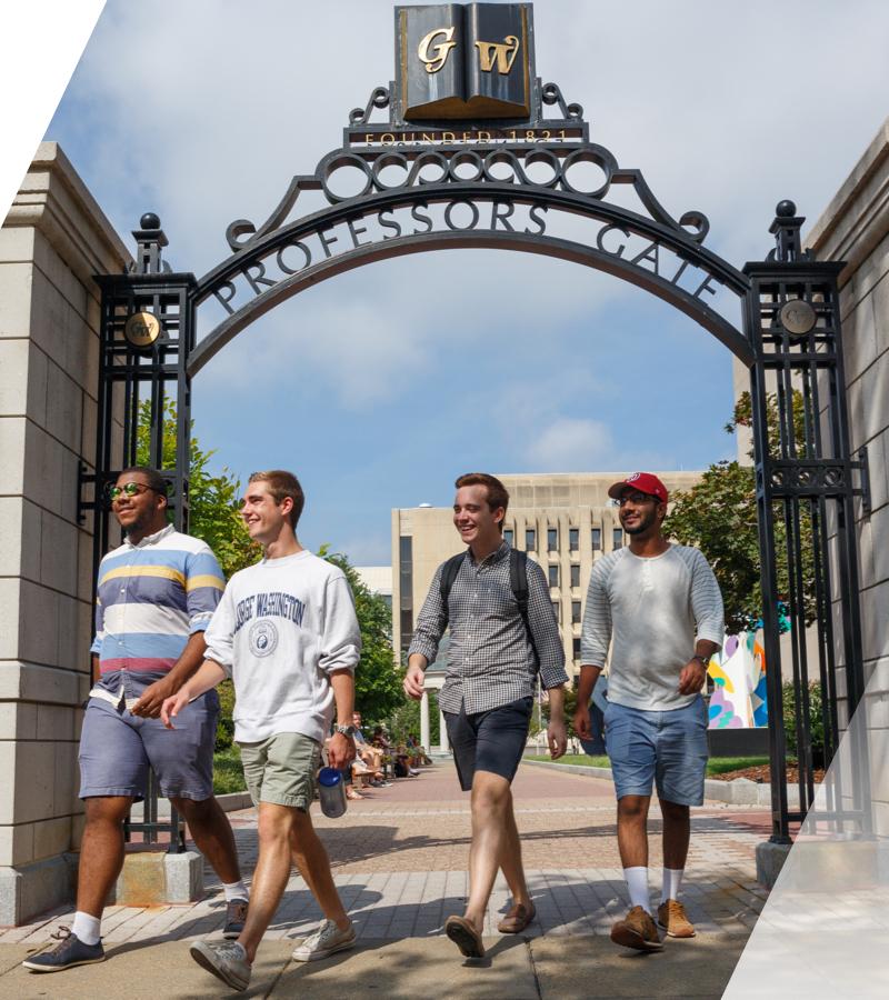 Students walking under gate