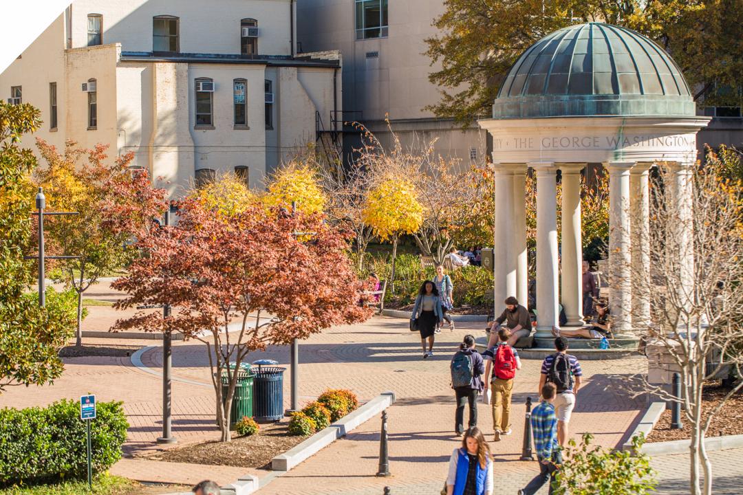 Kogan Plaza tempietto with students walking through and the leaves changing colors during the Autumn season