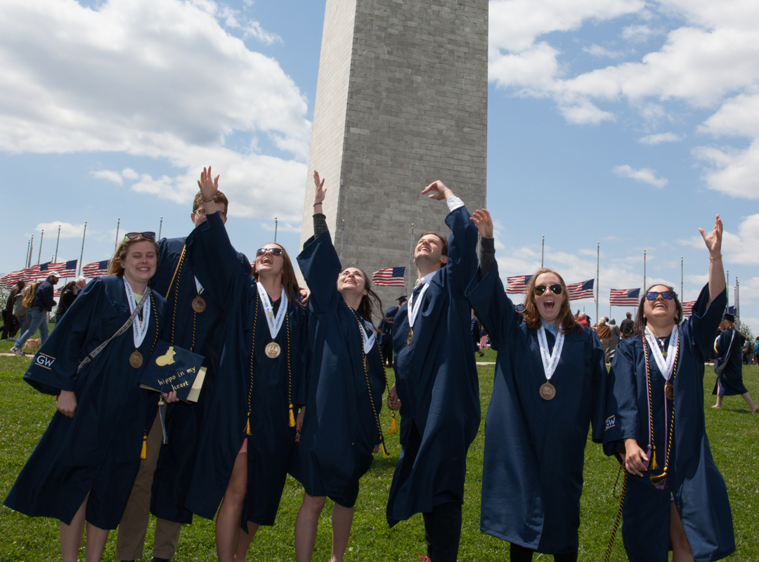 students in front of monument