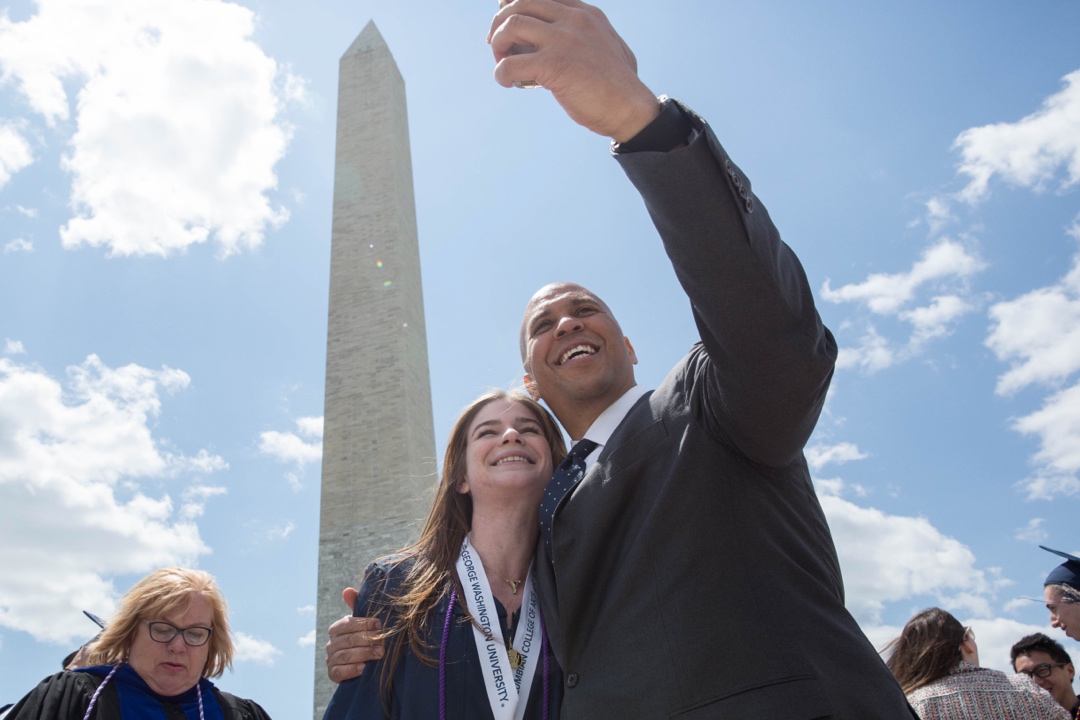Cory Booker and a student at commencement on the National Mall