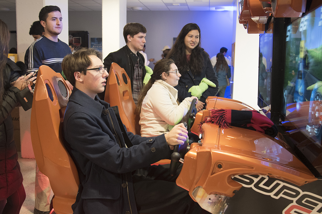student playing an driving arcade game