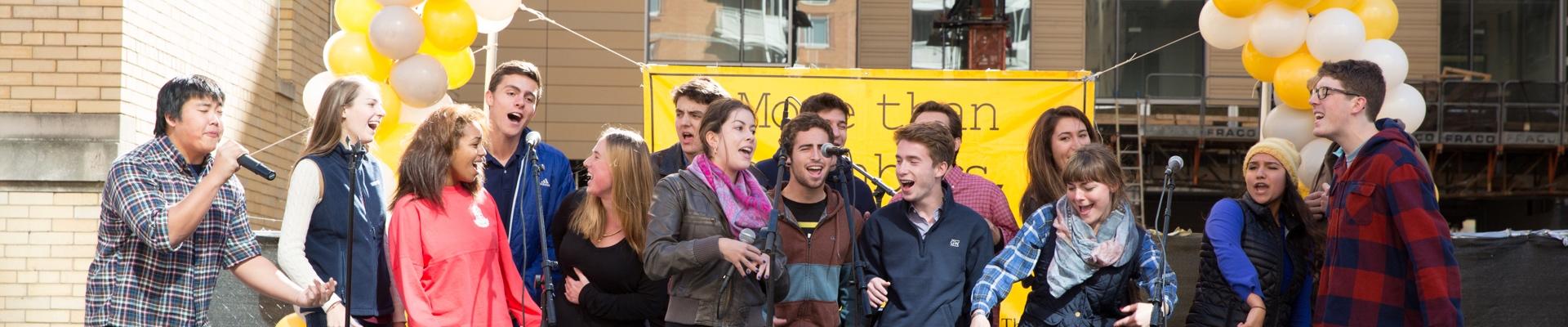 students singing on stage