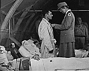 ER pinning medal to soldier, Santo, 1943